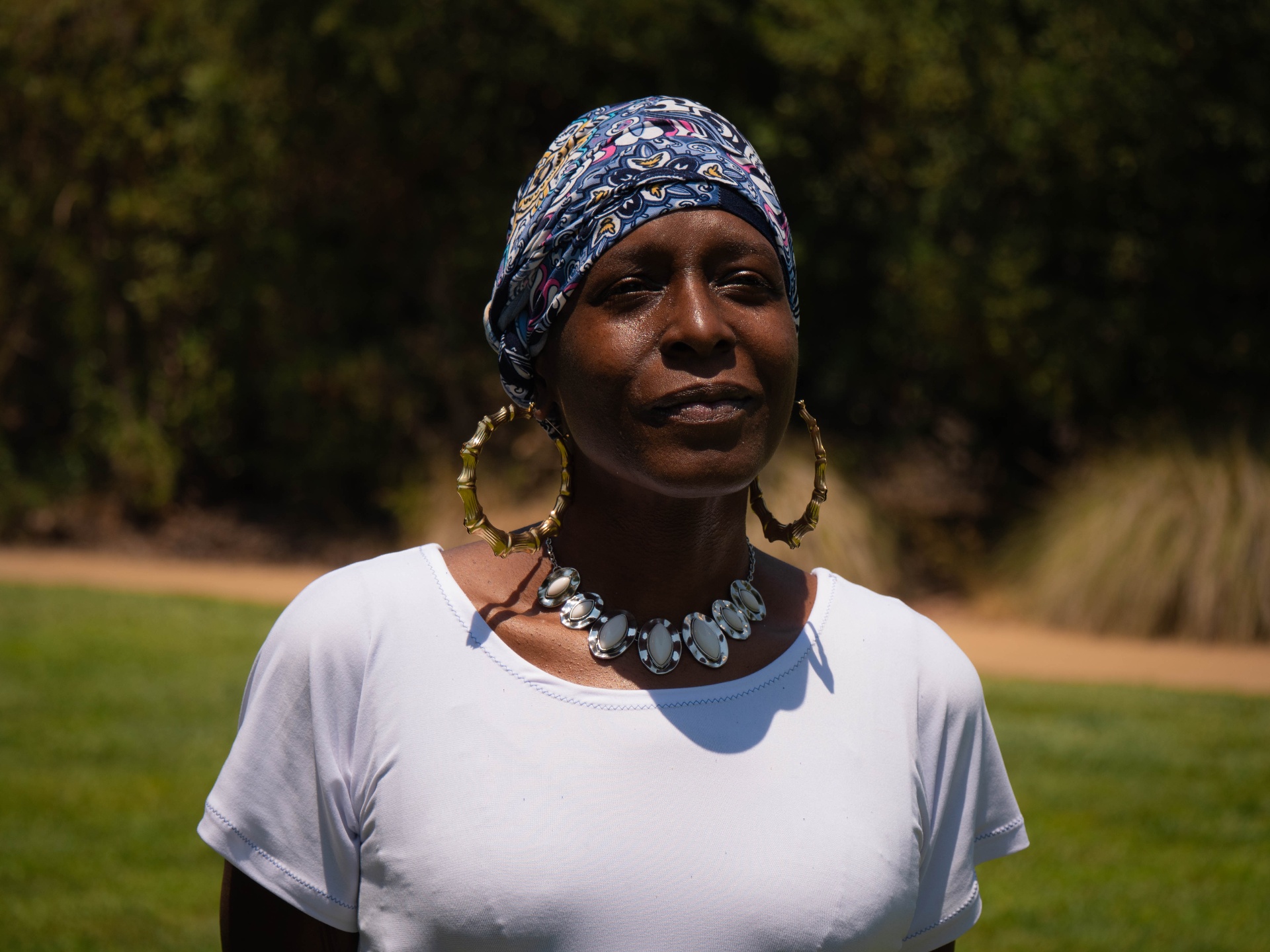 Outdoor portrait of a woman wearing a patterned blue headwrap