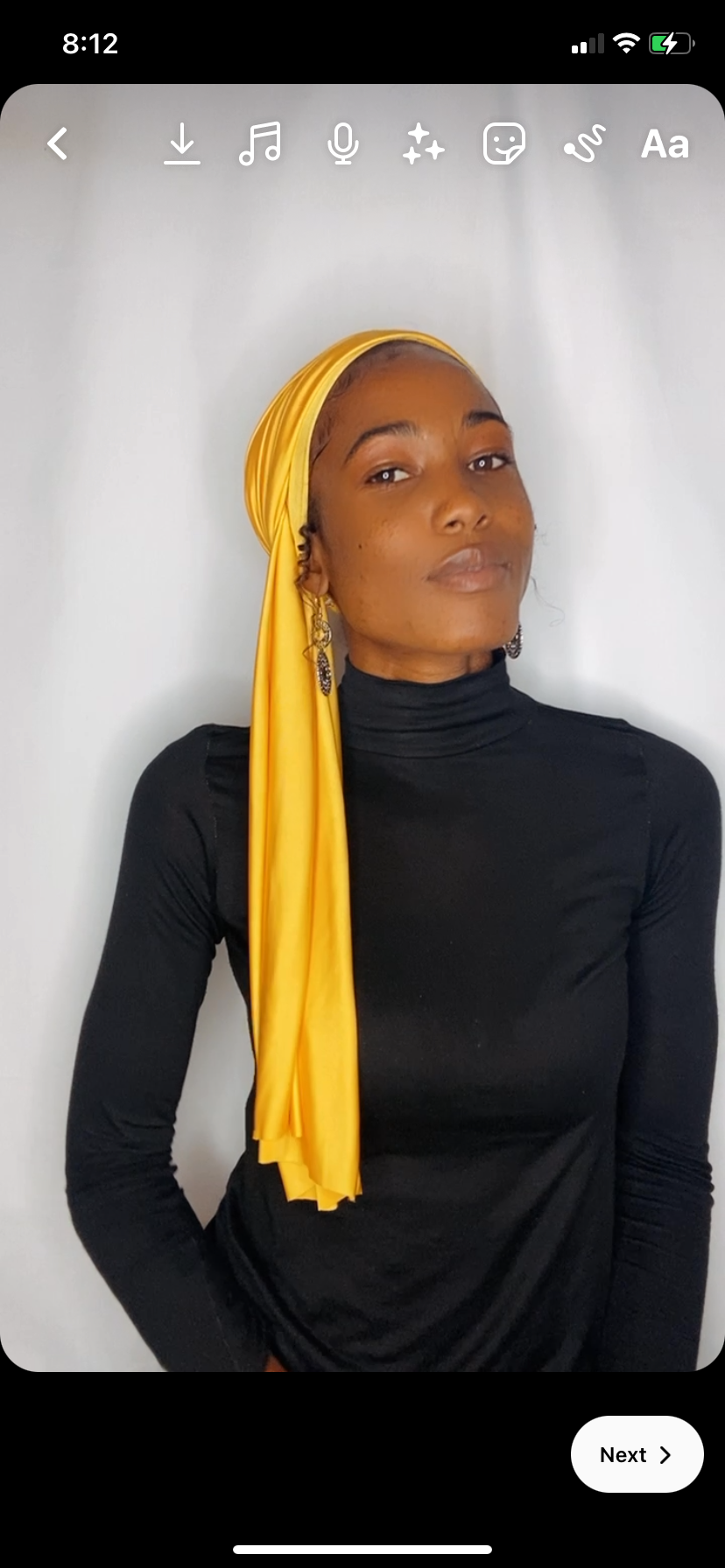 Side profile of a woman wearing a saffron yellow Krown with the length cascading down her back